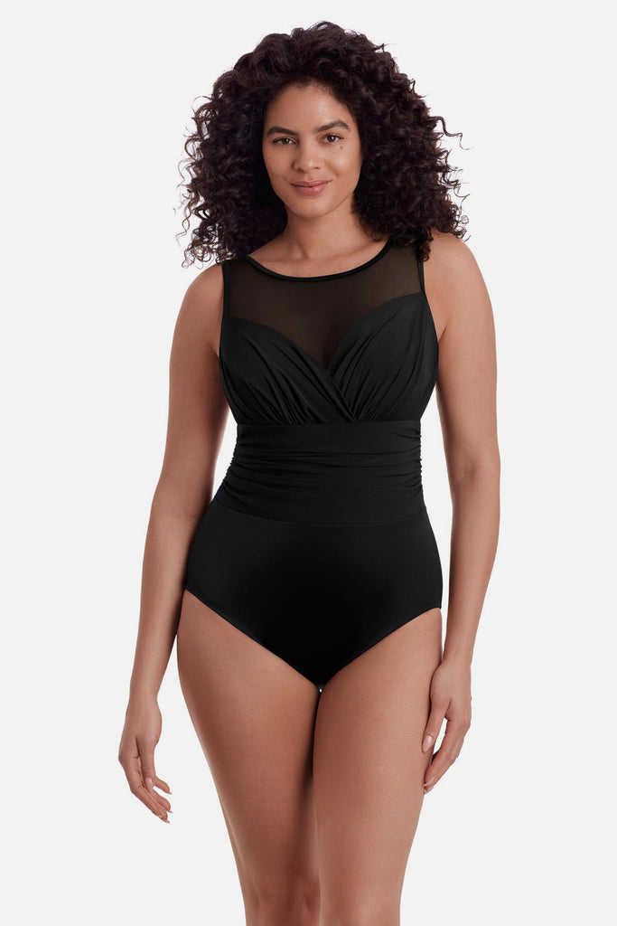 Woman wearing a black one-piece swimsuit with a mesh high neck