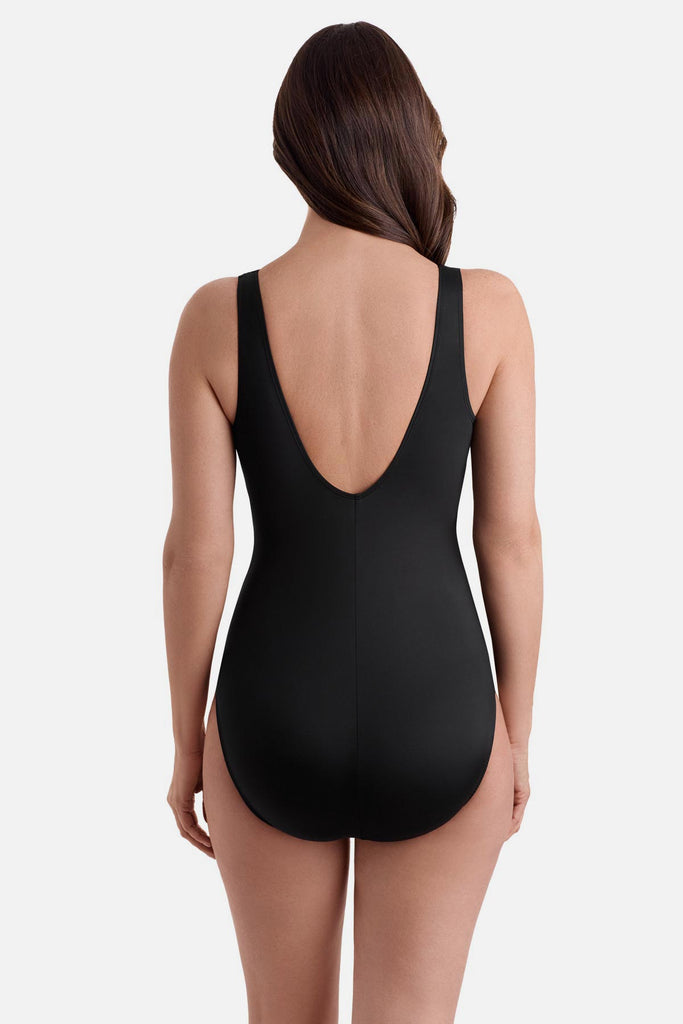 Woman turned away wearing a black swimsuit with a scoop back 