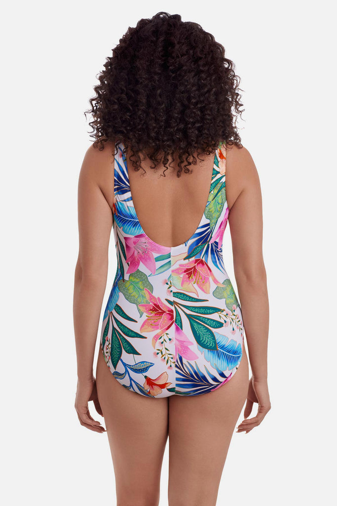 Woman turned away wearing a multicolored floral printed one-piece swimsuit 