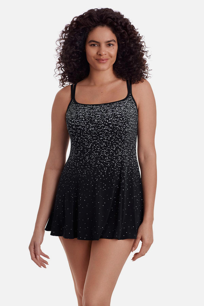 Woman wearing a black and white speckled swim dress 