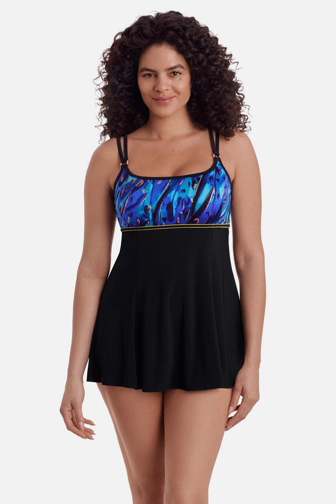 Woman wearing a swim dress with a blue and gold print on the bust