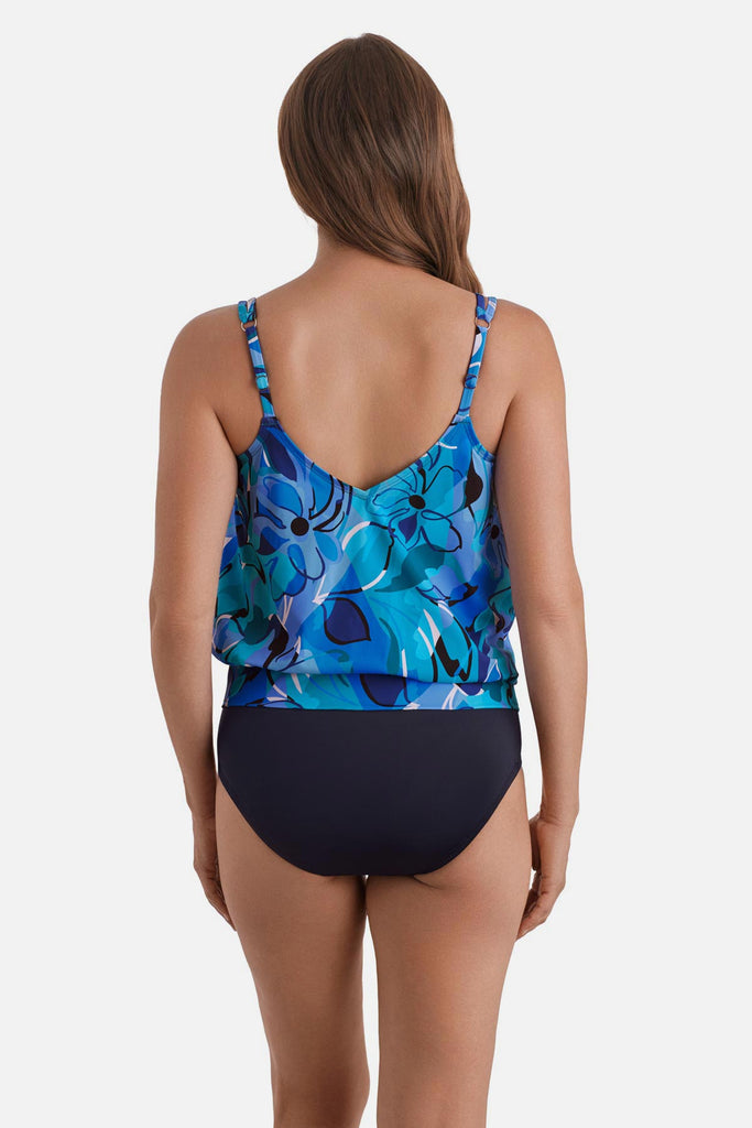 Woman turned away wearing a blue floral printed one-piece blouson swimsuit