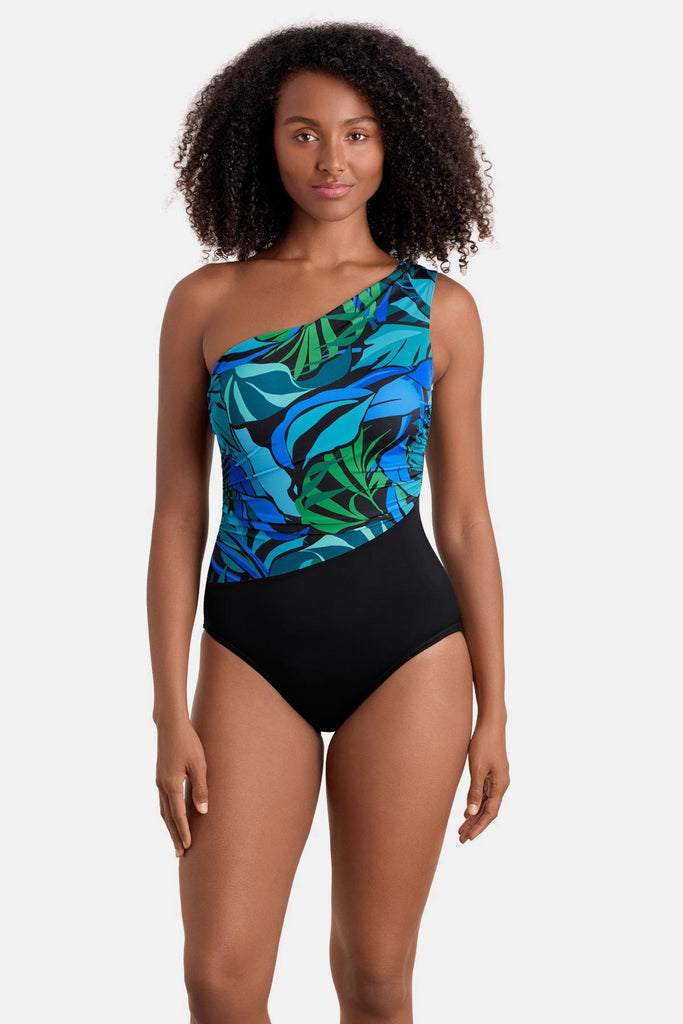 Woman wearing a blue and green palm leaf printed one shoulder one-piece swimsuit