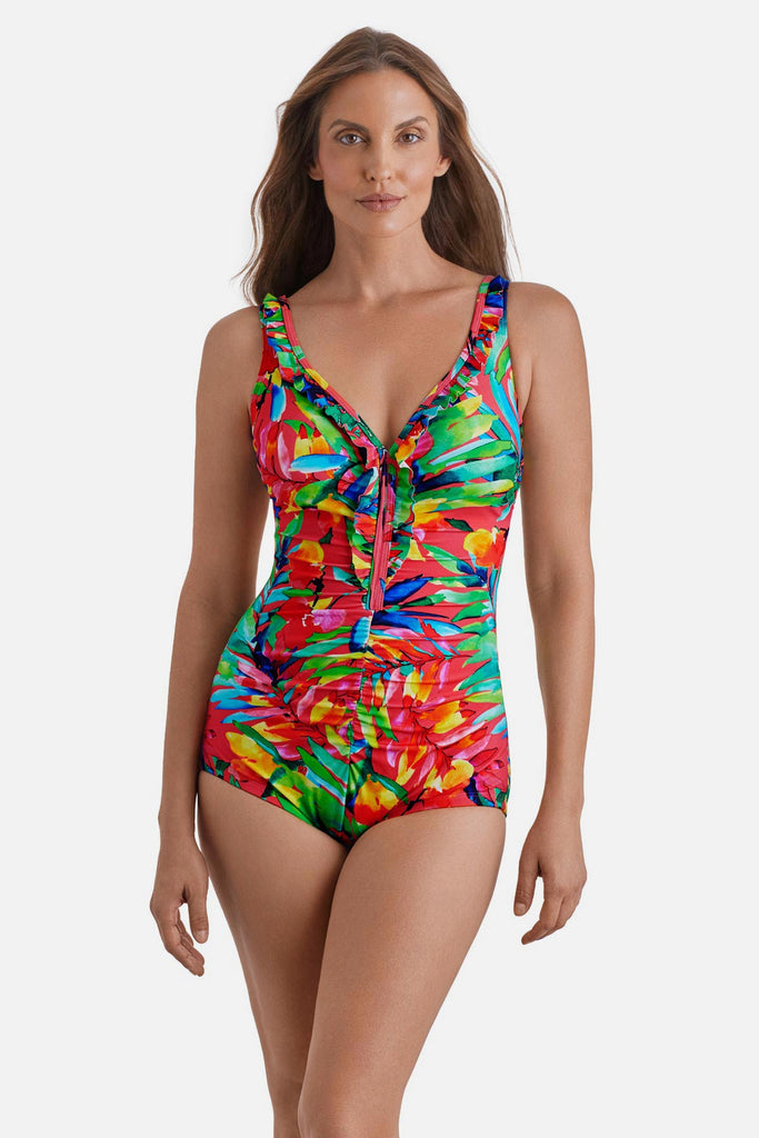 Woman wearing a multicolor palm leaf printed one-piece swimsuit with ruffles down the front