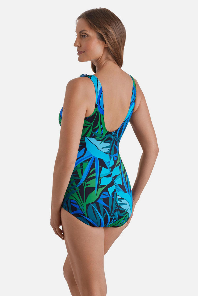 Woman turned left wearing a blue and green one-piece swimsuit with ruffles down the front