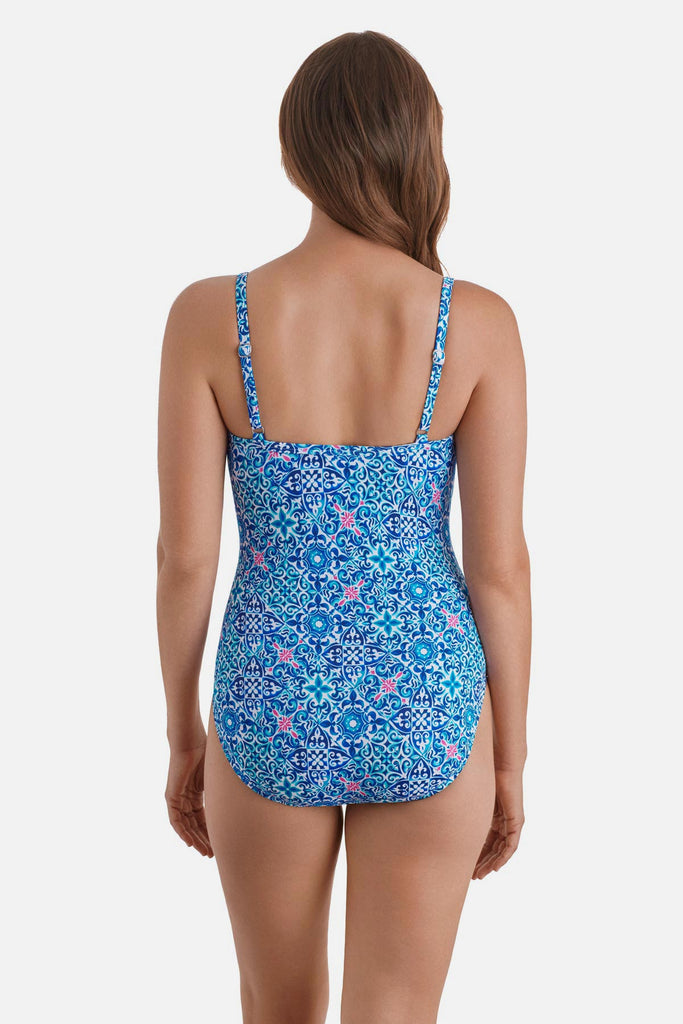 Woman turned away wearing a blue tile print one-piece swimsuit