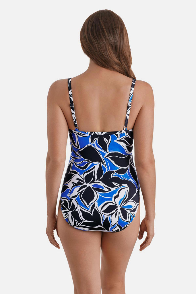 Woman turned away wearing a black, blue and white floral printed one-piece swimsuit