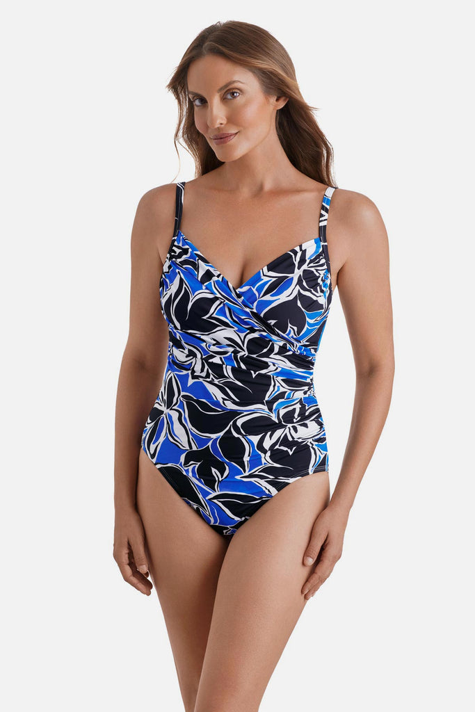Woman wearing a black, blue and white floral printed one-piece swimsuit