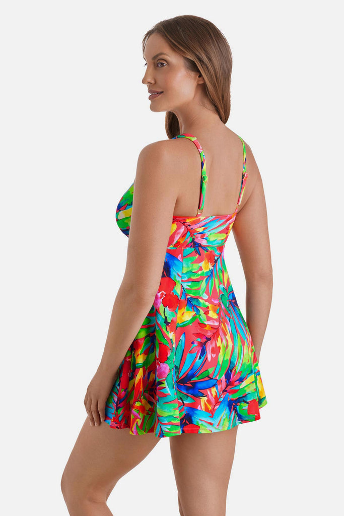 Woman turned left wearing a multicolor palm leaf printed swim dress with a tie in the front