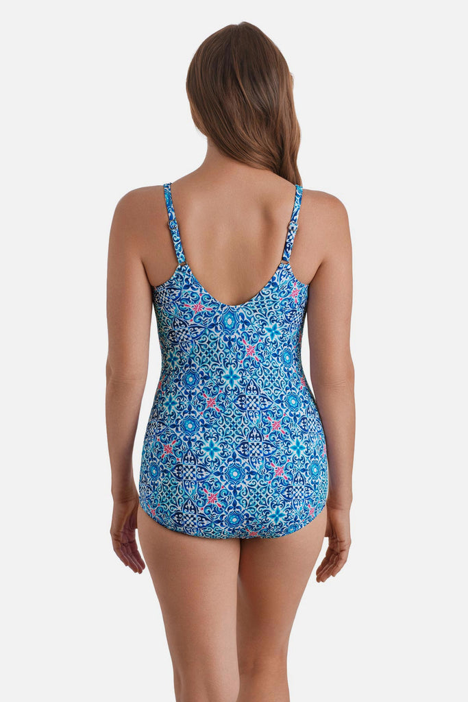 Woman turned away wearing a blue tile printed one-piece sarong swimsuit