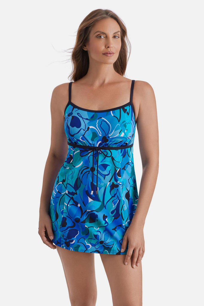 Woman wearing a blue floral printed swim dress with a tie around the waist