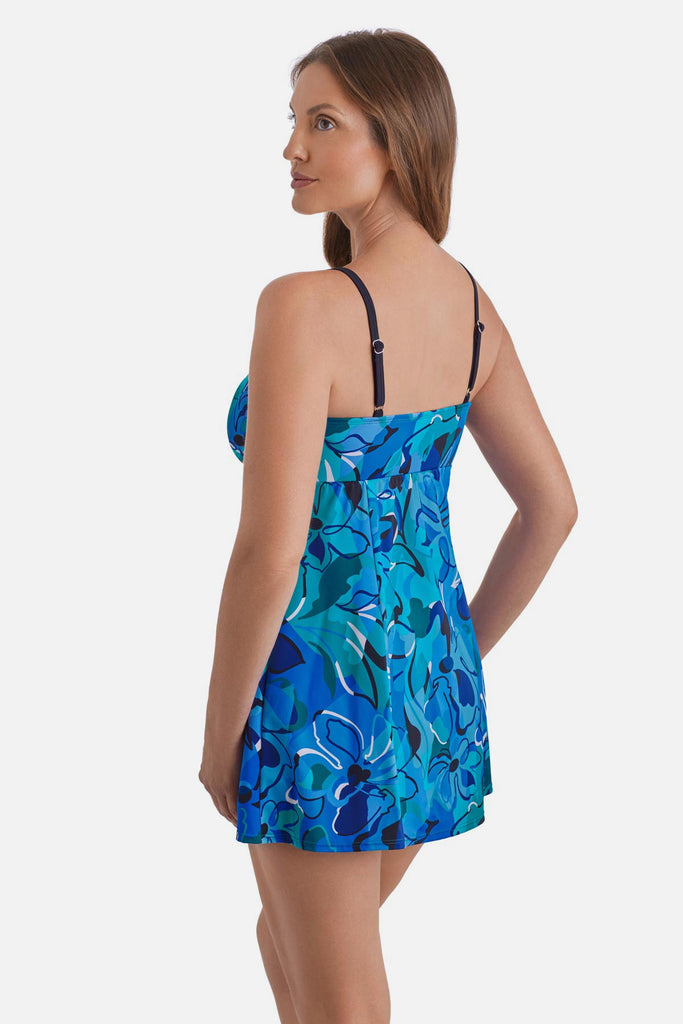 Woman faced left wearing a blue floral printed swim dress 