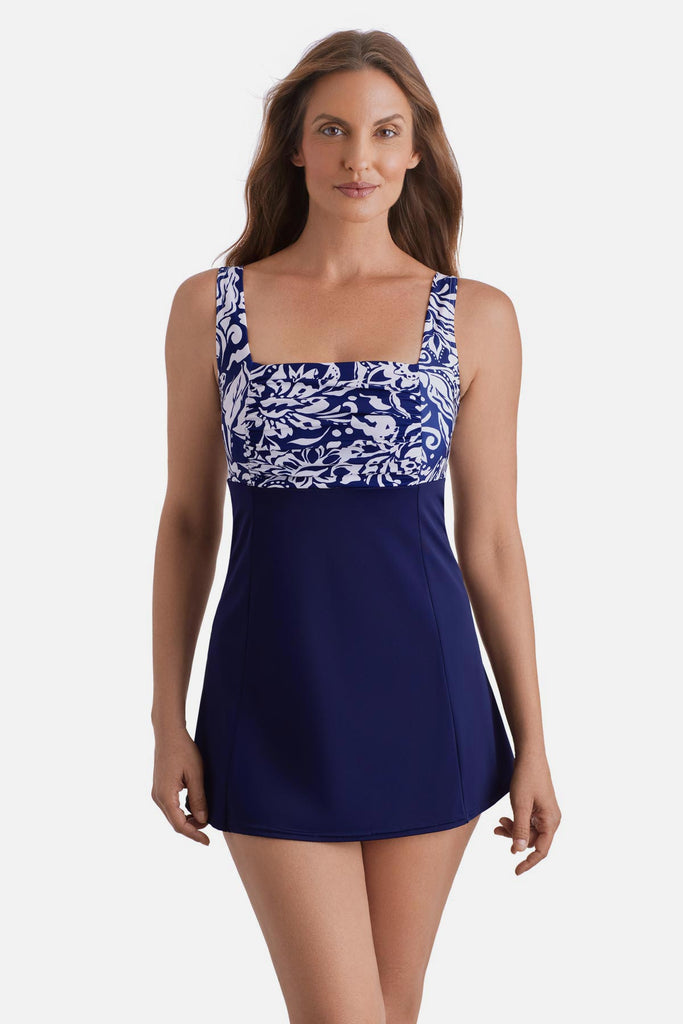 Woman wearing a blue and white abstract floral printed swim dress