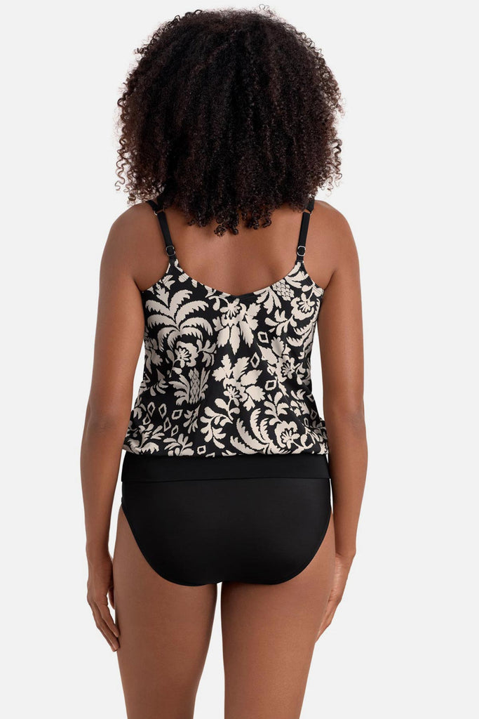Woman turned away wearing a black and white palm tree print blouson tankini top