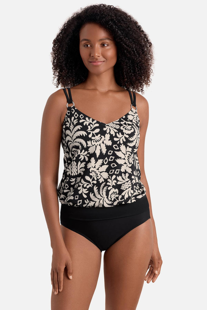 Woman wearing a black and white palm tree print blouson tankini top