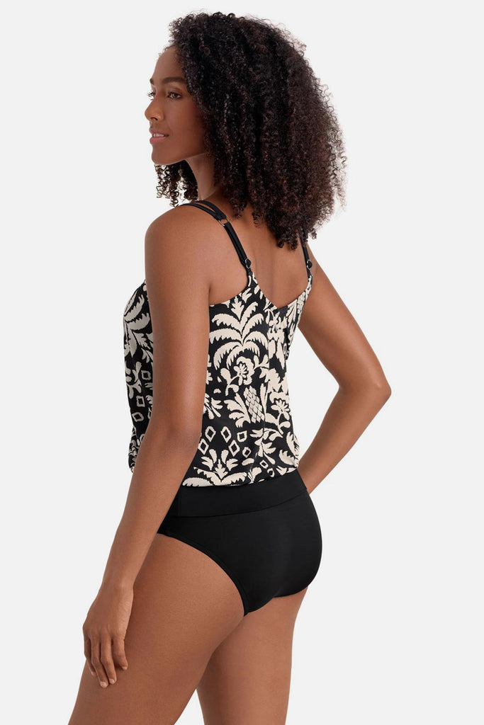 Woman turned left wearing a black and white palm tree print blouson tankini top