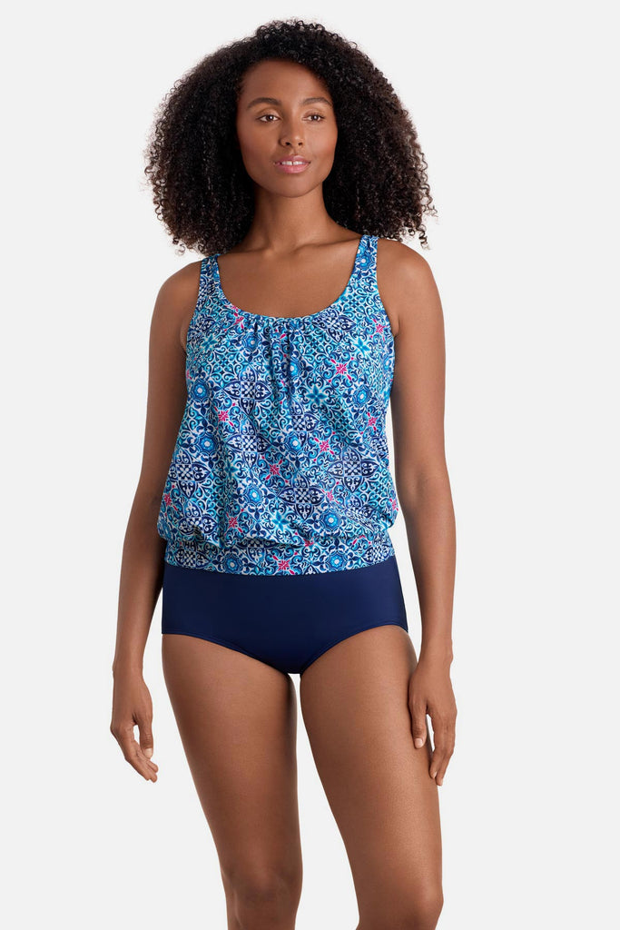 Woman wearing a blue tile print shirred neck blouson tankini top