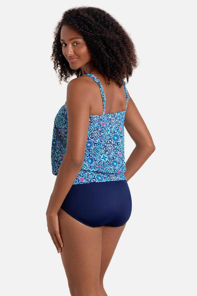 Woman turned left wearing a blue tile print shirred neck blouson tankini top
