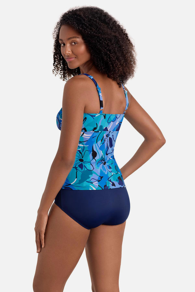 Woman turned left wearing a blue floral printed shirred tankini top