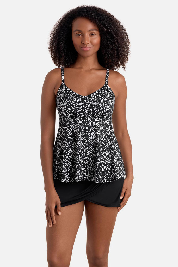 Woman wearing a black and white dotted print tankini top