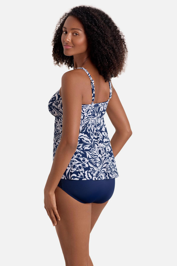 Woman turned left wearing a blue and white abstract floral printed tankini top