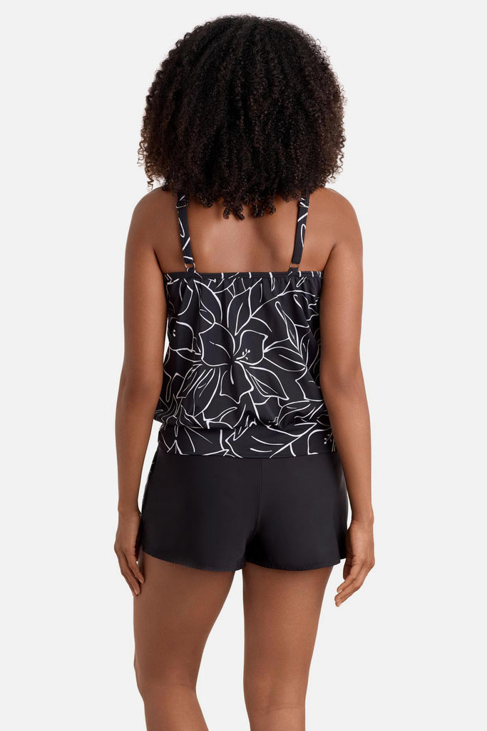 Woman turned away wearing a black and white floral outline pattern high neck tankini top