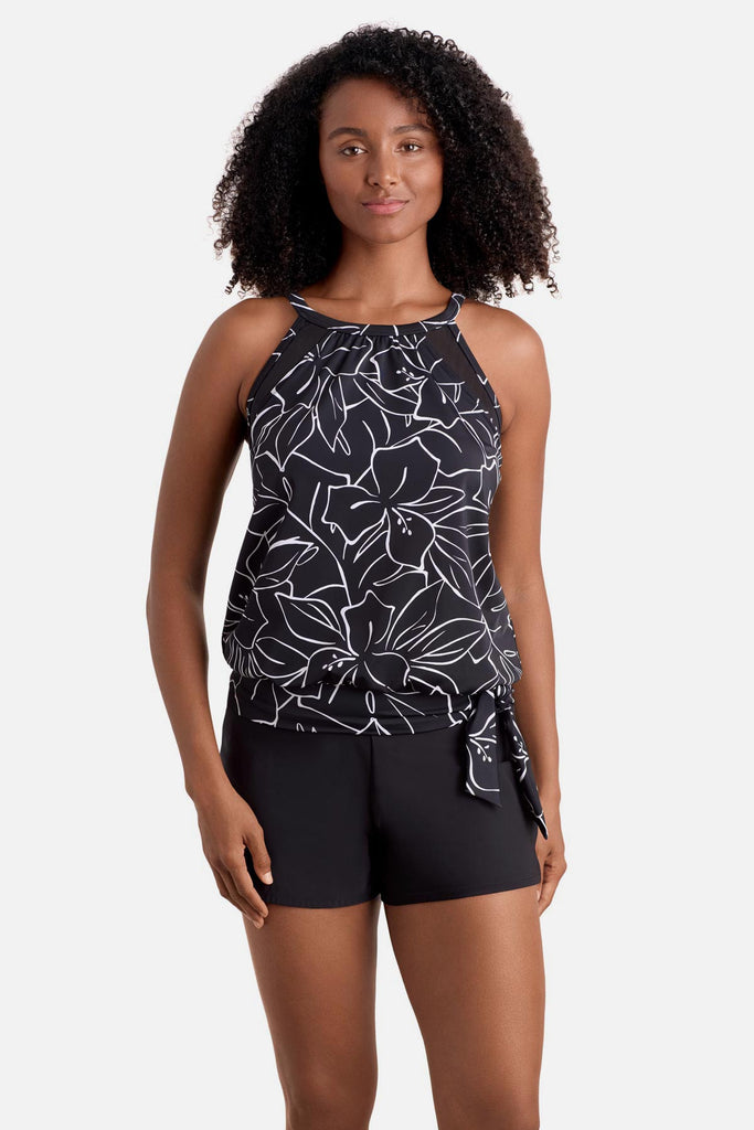 Woman wearing a black and white floral outline pattern high neck tankini top