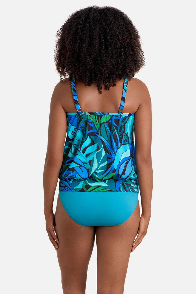 Woman turned away wearing a blue and green palm leaf printed blouson tankini top