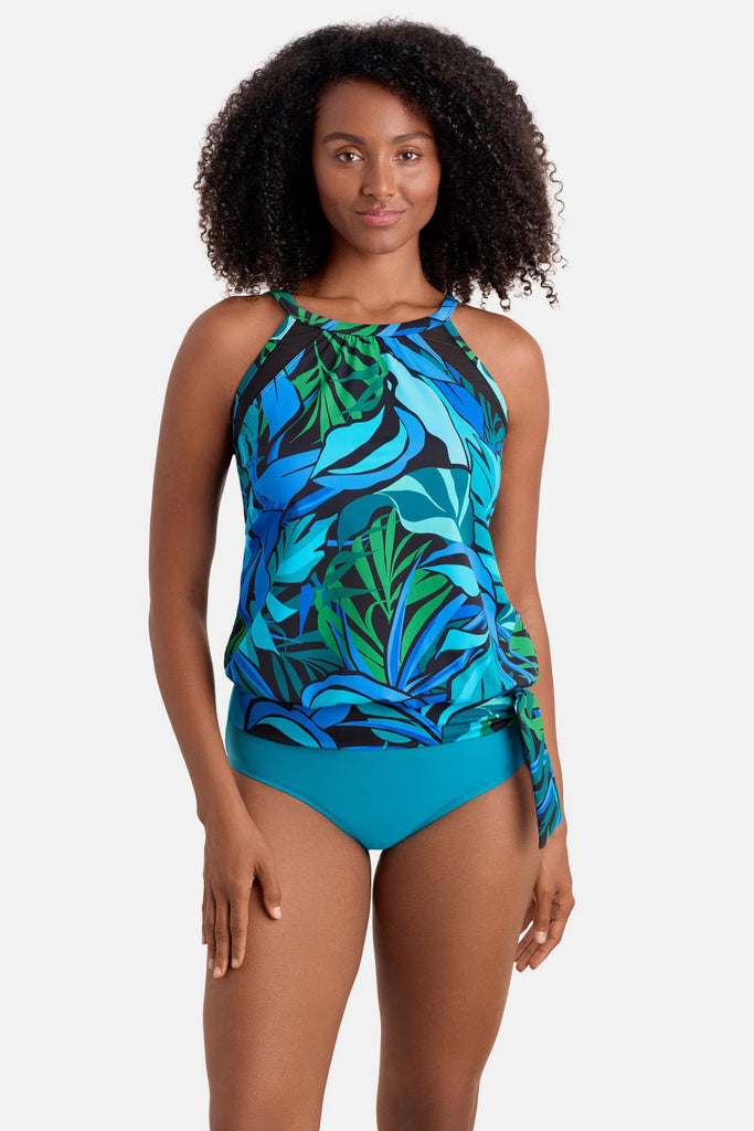 Woman wearing a blue and green palm leaf printed blouson tankini top