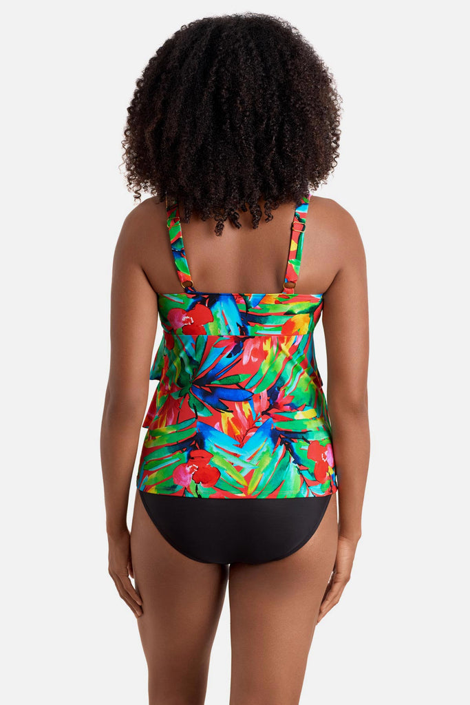 Woman turned away wearing a multicolored palm leaf printed tankini top with ruffles