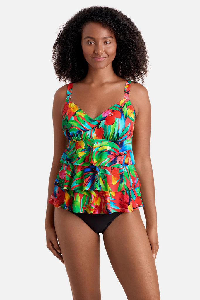 Woman wearing a multicolored palm leaf printed tankini top with ruffles