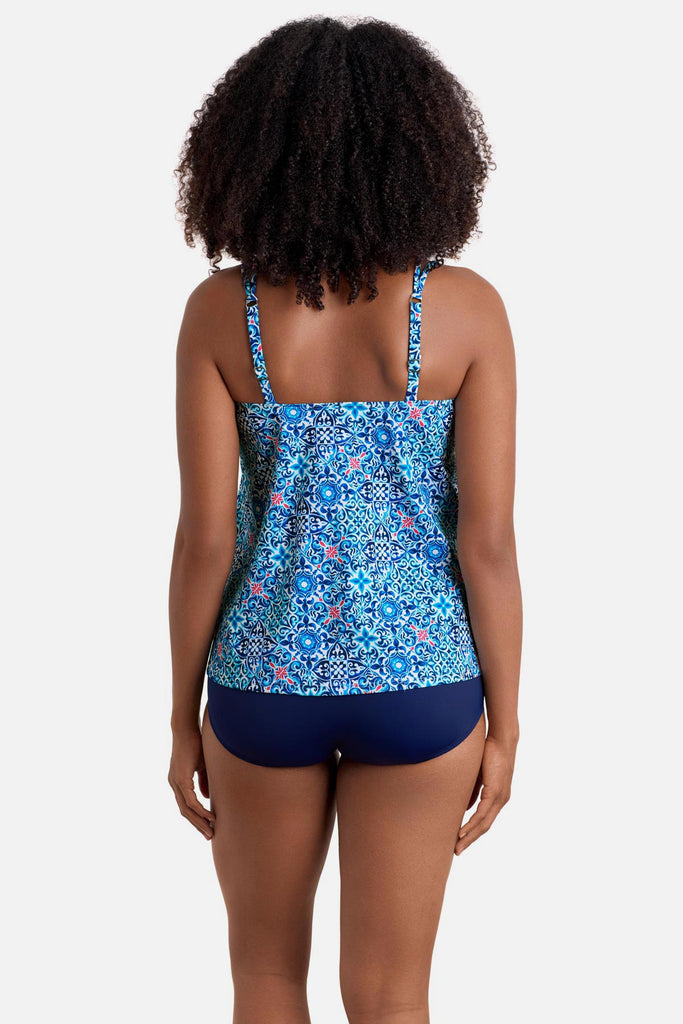 Woman turned away wearing a blue tile print handkerchief tankini top