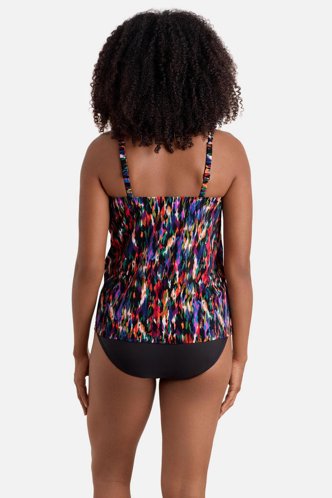 Woman turned away wearing a multicolored abstract printed handkerchief tankini top